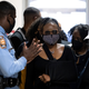Georgia State Rep. Park Cannon, D-Atlanta, walks past a Georgia State Patrol officer as she returns to the State Capitol in Atlanta on March 29, 2021 after being arrested last week for knocking on the governor’s office door as he signed voting legislation.